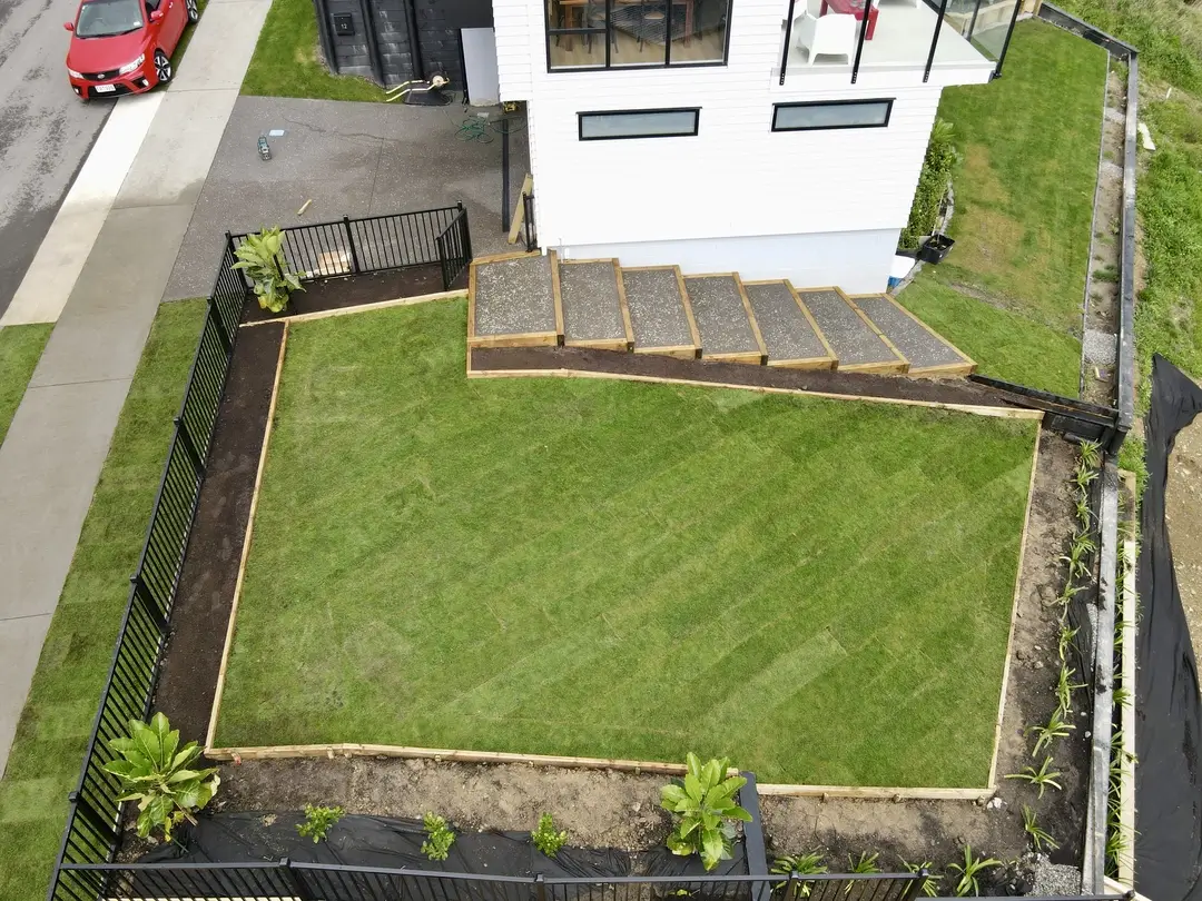 Professional Kapiti landscaping transformation - custom retaining walls decking and outdoor living area Wellington